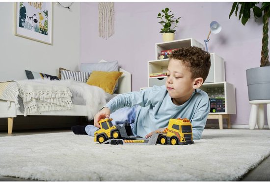 Child playing with toy construction vehicles in a bedroom