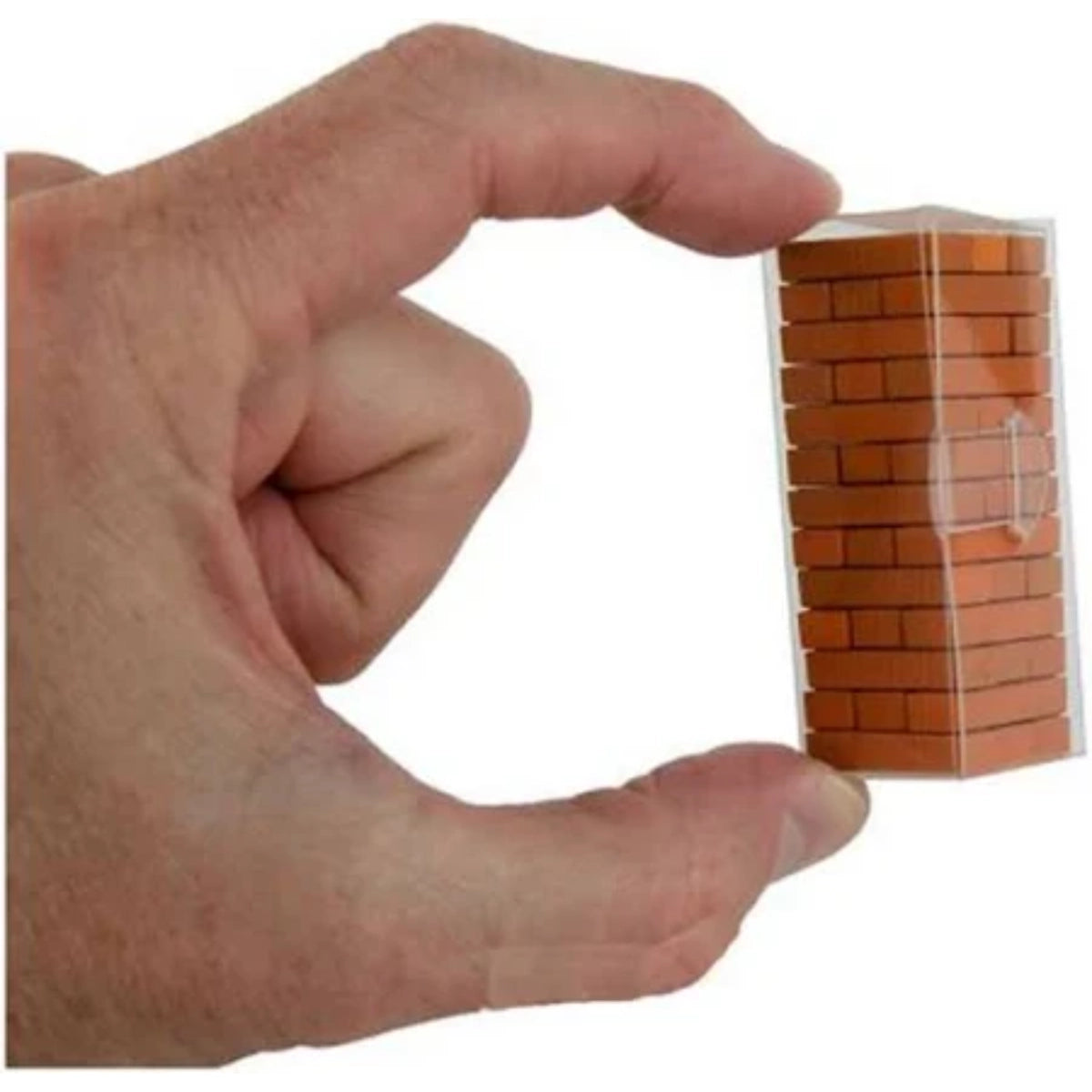 Hand holding a clear plastic container filled with small orange bricks against a white background